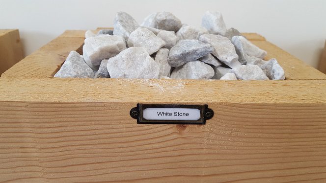 A wooden box with some rocks in it